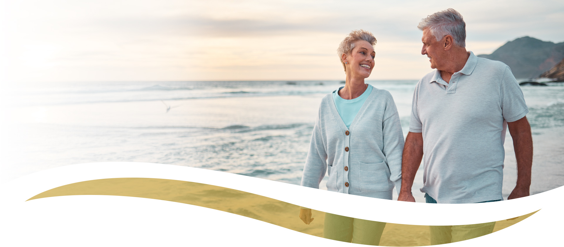 mature couple walking on beach