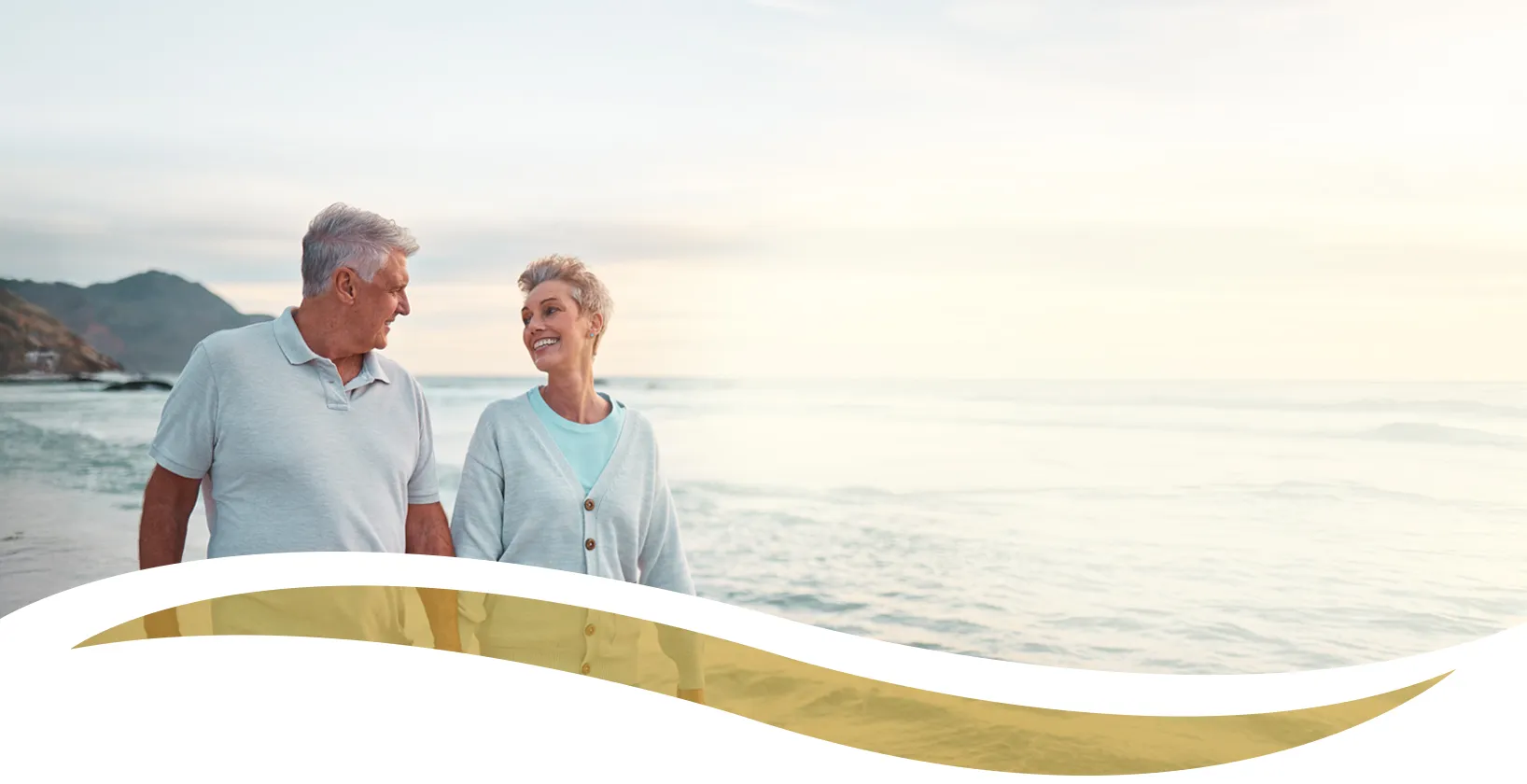 mature couple walking on beach