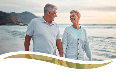 mature couple walking on beach