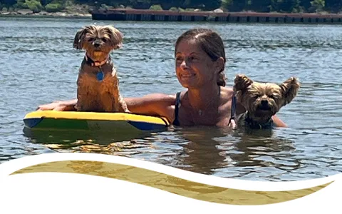 Yvonne swimming with her dogs in lake